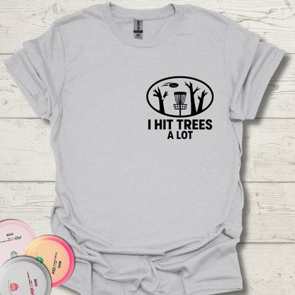 Disc golf shirt with I Hit Trees a Lot text and tree graphic. Unisex I Hit Trees a Lot frisbee golf tee laid flat with discs. Funny disc golf gift shirt for players who always hit trees.
