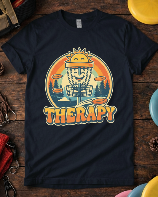 Retro funny disc golf shirt that says Therapy with basket graphic. Unisex disc golf is my therapy tee laid flat with colorful discs.