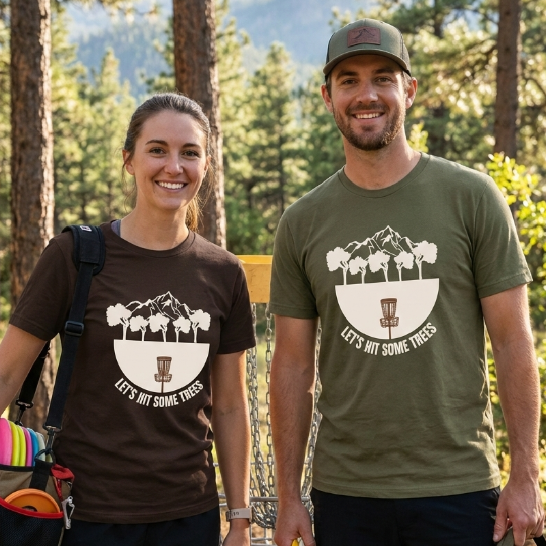 disc golf couple wearing funny shirts. Disc golfers wearing let's hit some trees t-shirts on the disc golf course.